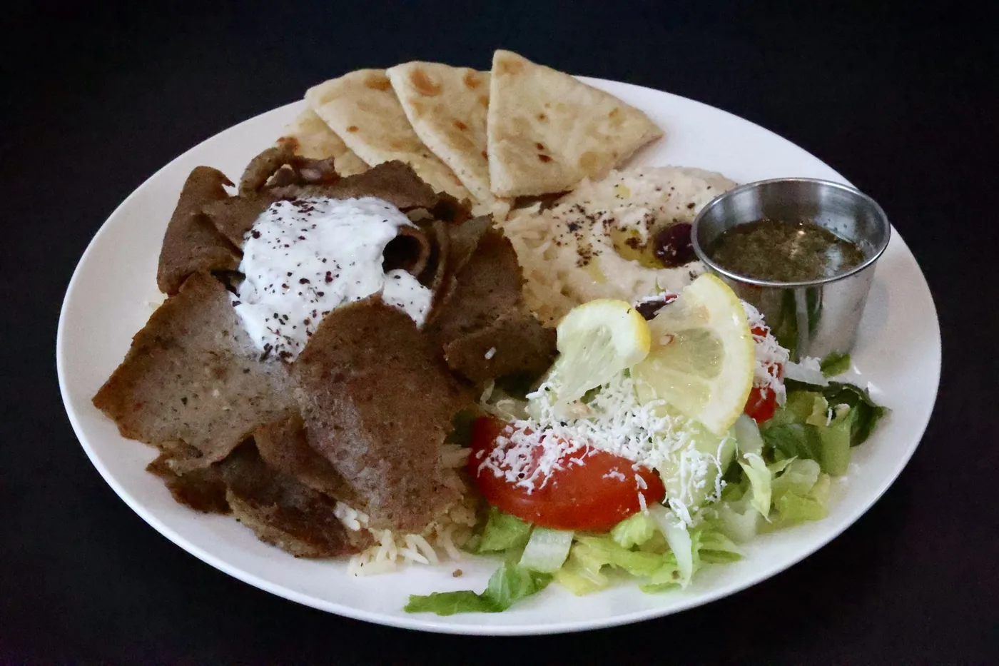 Gyro plate with tzatziki, hummus, seasoned rice, house salad with feta and warm pita at Leymoon Kitchen